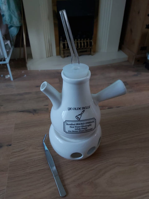Customer photo: the assembled Ye Olde Bells steamer with mouthpiece and tweezers on a wooden floor